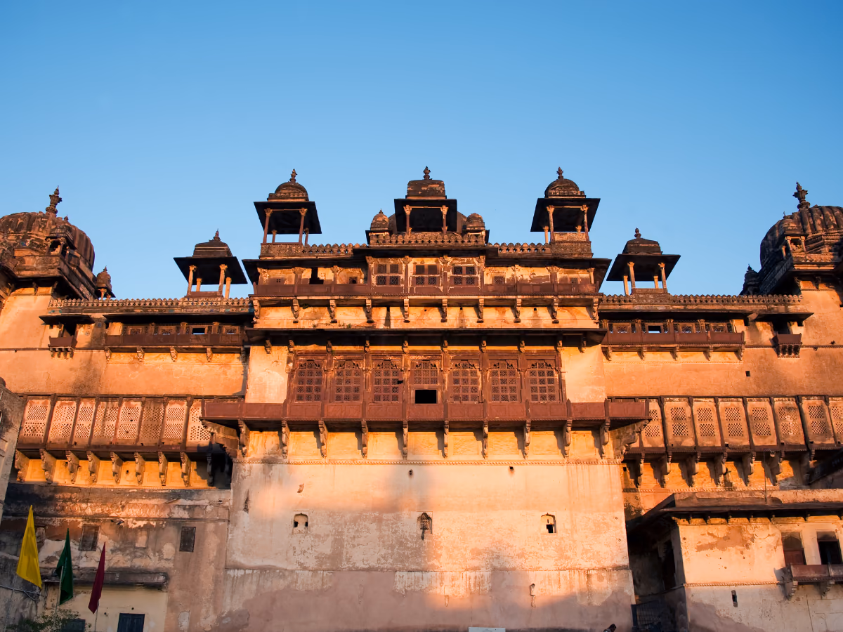 Orchha's Bundela palace architecture in warm evening light.