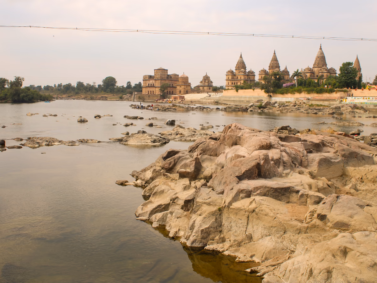 The cenotaphs of Orchha beside the Betwa River at sunset.