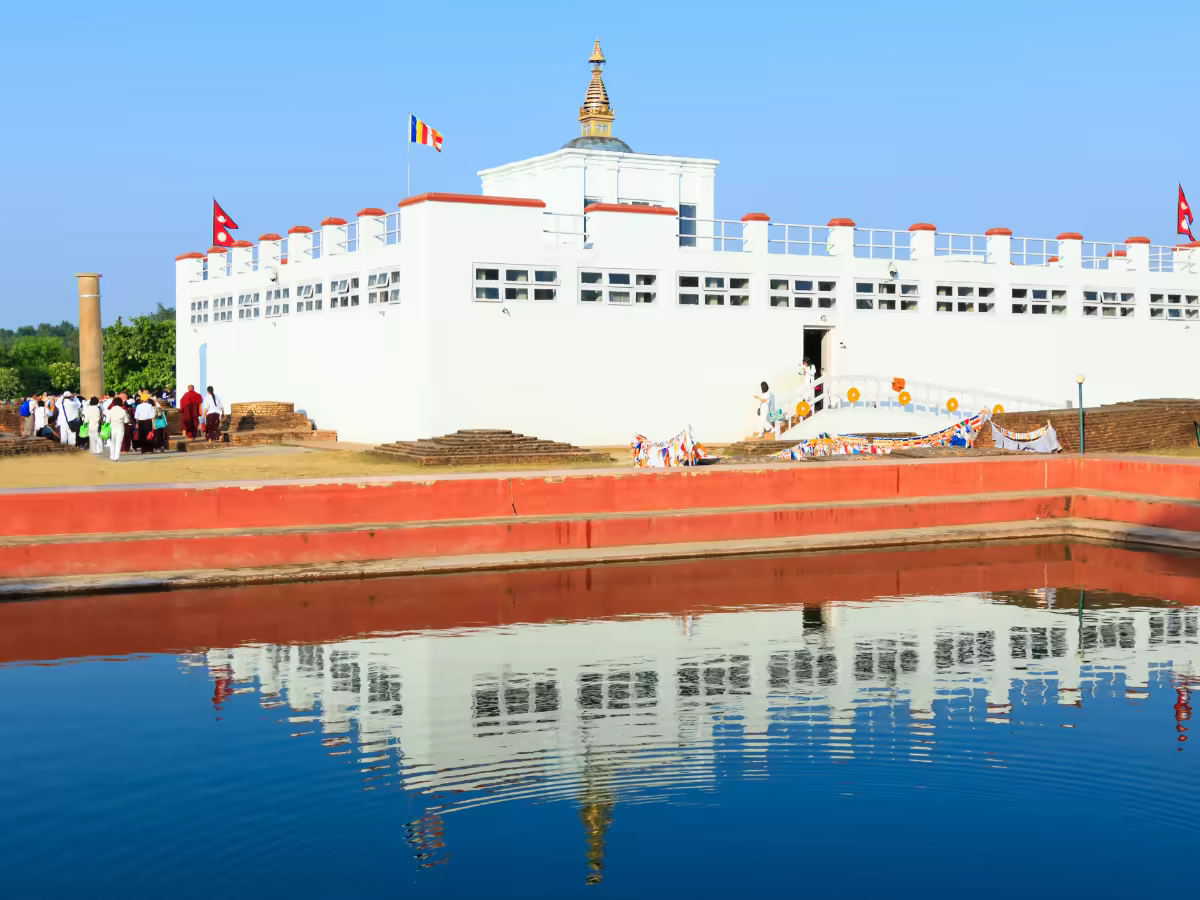 A quiet garden path leading toward a monastery in Lumbini.