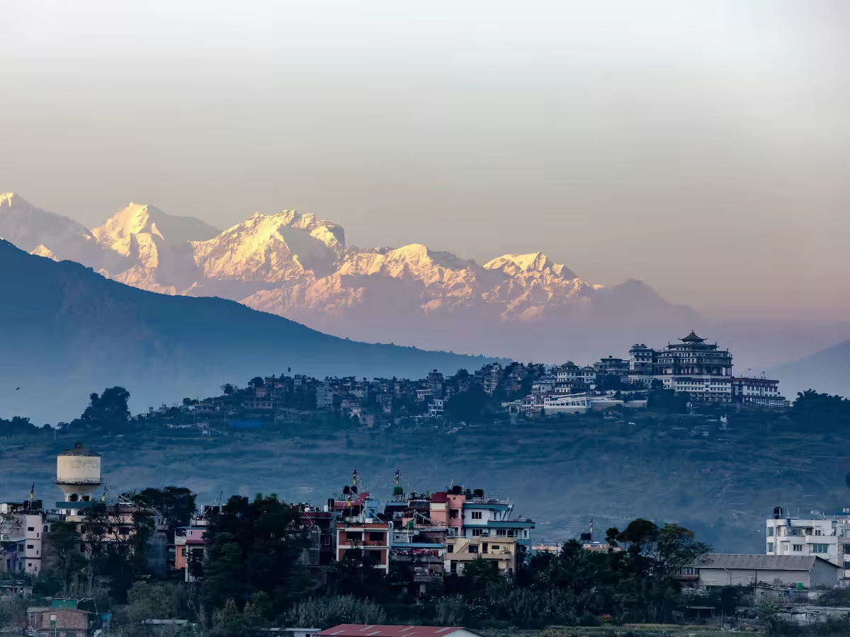 Prayer flags and a quiet Kathmandu lane in morning light.