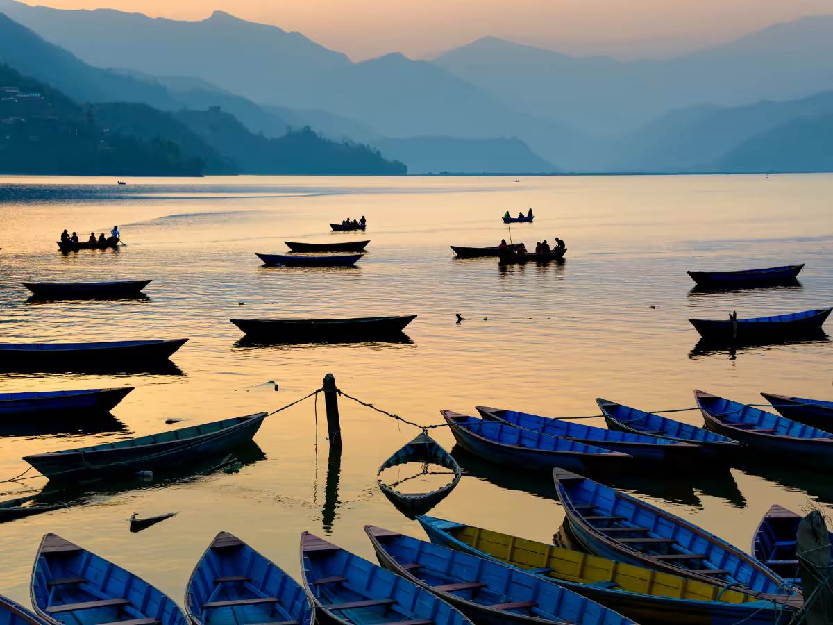 A quiet boat and mountain reflection on Phewa Lake.