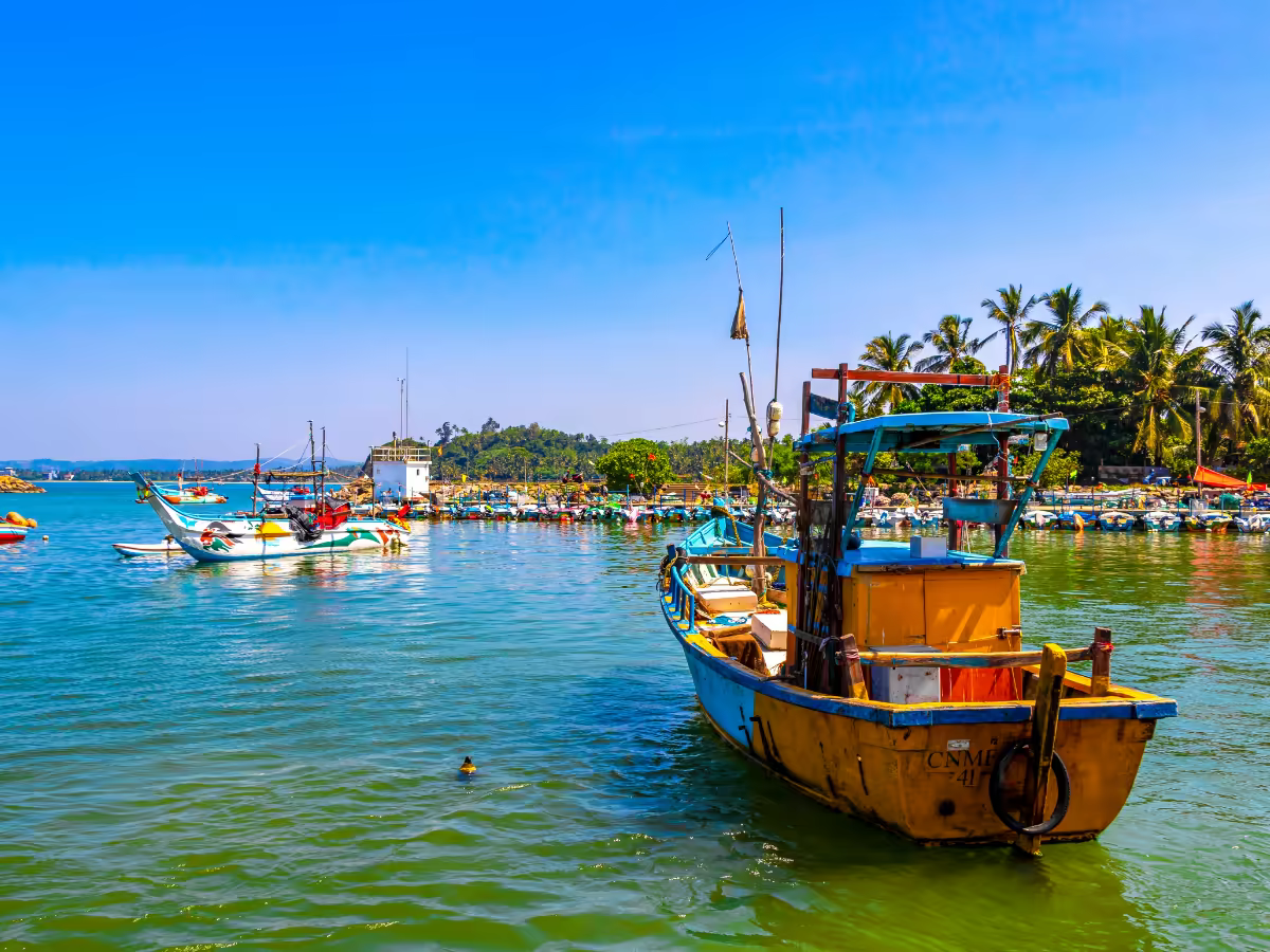 A fishing boat above the tide line on Mirissa beach.