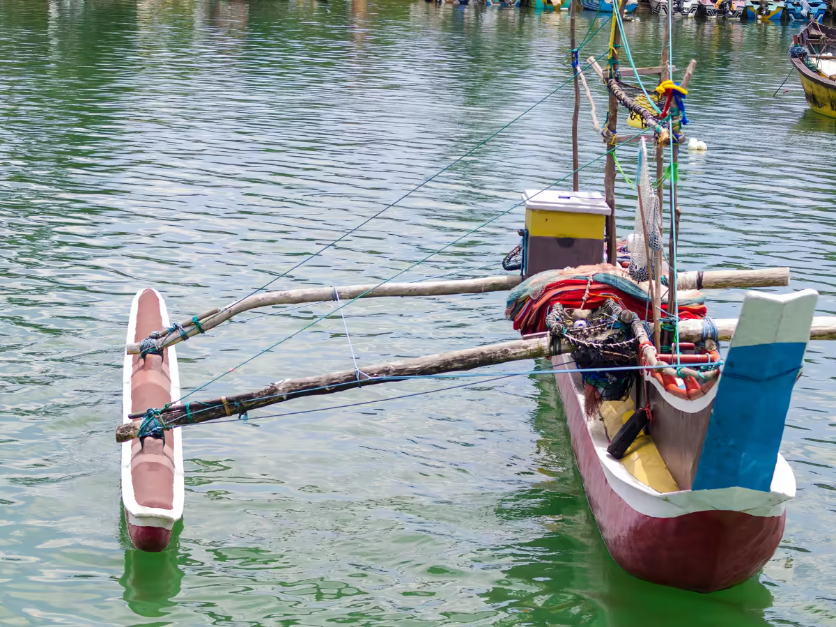 A traditional fishing boat on calm water off Mirissa.