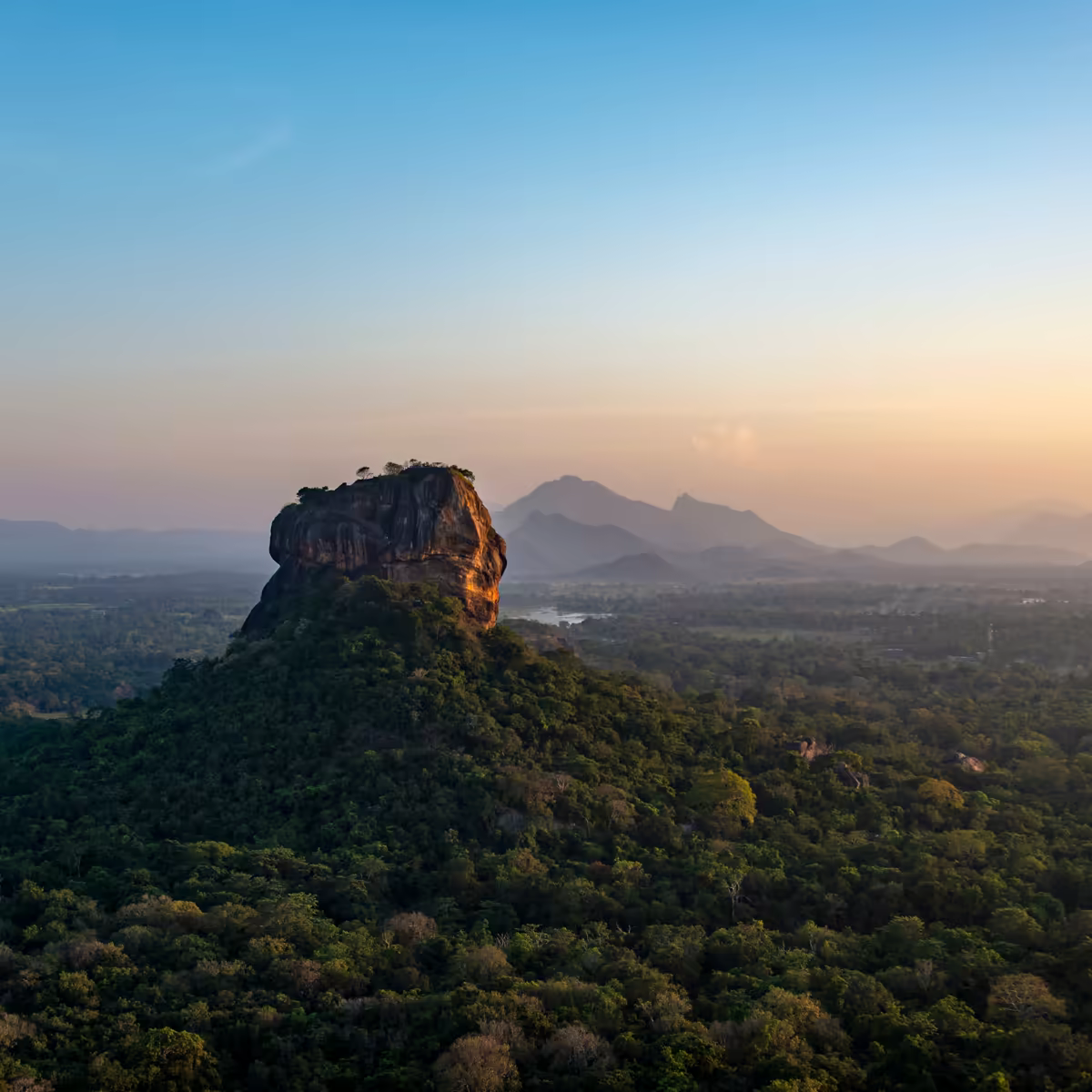 Sigiriya rising above Sri Lanka's green dry-zone forest.
